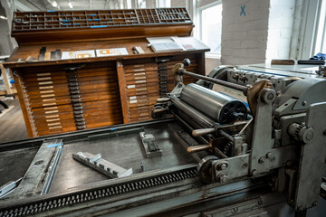 Setting type on a letterpress.