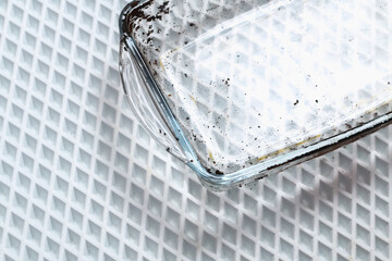 Dirty baking dish with a thick layer of carbon. Glassware for baking with soot, carbon deposits, old dried fat.