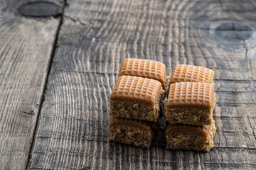 Tasty caramel candy on rustic wooden table