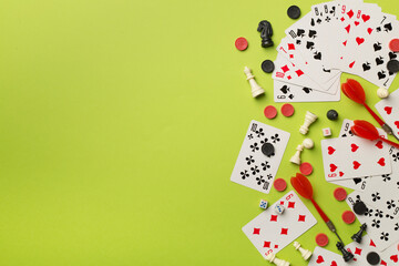 Different board games on color background, top view