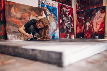 Female painter artist painting and creating her art in a creative studio