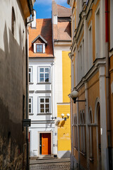 Fototapeta na wymiar Cheb, Western Bohemia, Czech Republic, 14 August 2021: narrow picturesque street with medieval colorful gothic merchant houses, Eger at sunny summer day, historic renaissance and baroque buildings