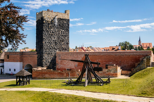 Cheb, Western Bohemia, Czech Republic, 14 August 2021: Gothic stone castle, medieval historic fortress or stronghold in sunny summer day, black Tower, ballista wooden siege weapons near defense walls