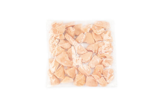 Chicken Fresh Meat In A Transparent Bag.Frozen Pieces Of Chicken Fillet On An Isolated White Background.