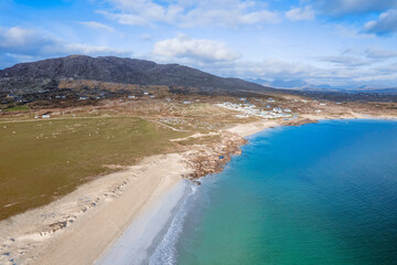 Beautiful Gurteen bay beach and blue color ocean water, cloudy sky. Stunning Irish nature scene in county Galway, Ireland. Warm sunny day. Popular travel area with stunning scenery