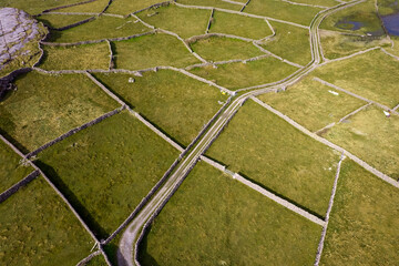 Aerial view on green fields separated by dry stone walls. Inishmore, Aran Islands. county Galway, Ireland. Popular travel destination with amazing Irish landscape scenery.