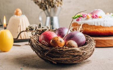 Traditional Ortodox Easter background. Easter eggs in a nest on a stone background.