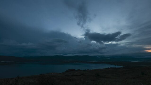 Time lapse of darkening stormy sky over Bannoe lake at South Ural, Russia 