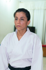 Fototapeta premium Portrait of female karate trainer at home