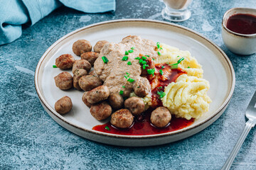 Swedish meatballs kottbullar, mashed potato, onion sauce and lingonberry sauce.