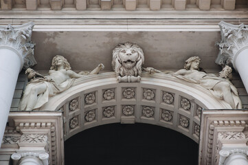 Sculptures of two muses above the arch. Allegory of arts and a lion on the facade of the Opera and Ballet Theater in Lvov. Neo-Renaissance in architecture.