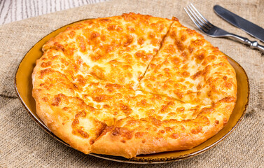 khachapuri with cheese, megrelian khachapuri, georgian cuisine on wooden table