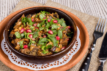 kuchmachi Georgian cuisine on old wooden table macro close up