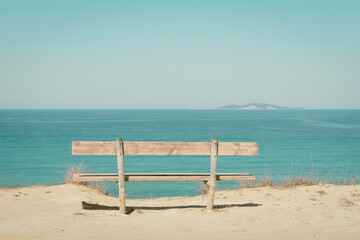Rustic bench facing the sea