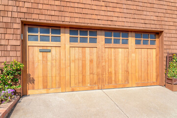Wooden bi-fold garage doors with glass panel at San Francisco, California