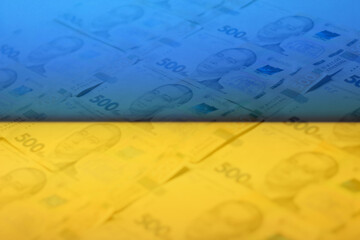 Naklejka premium Defocus ukrainian money backdrop. Background of the five hundred hryvnia banknotes. Close-up view. Ukraine economic. Paper money. Ukraine flag. Out of focus