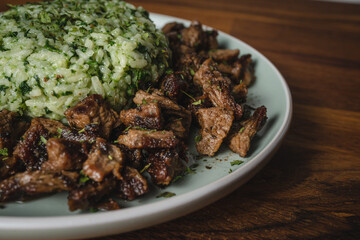 Beef and rice with spinach prepared meal in plate on the table ready to eat