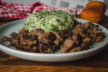 Beef and rice with spinach prepared meal in plate on the table ready to eat