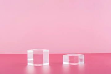 Acrylic blocks on pink background, pedestal cosmetic display glass podium platform for product...