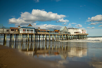 An old wooden pier with colorful cafes on the shores of the Atlantic Ocean. USA. Portland. old orchard beach, 