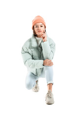 Pretty young woman in stylish warm clothes on white background