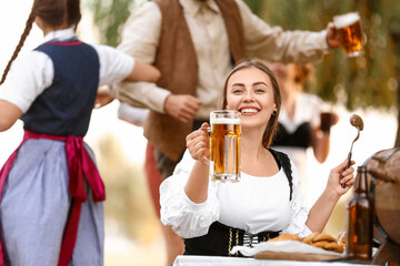 Happy woman celebrating Octoberfest outdoors