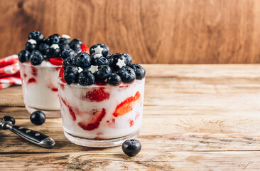 Two glasses of yogurt with berries. American patriotic breakfast. Selective focus.