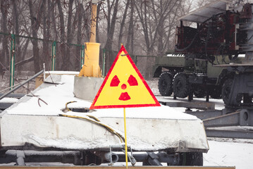 Radiation aware sign in Chornobyl near machines that eliminated the tragedy 
