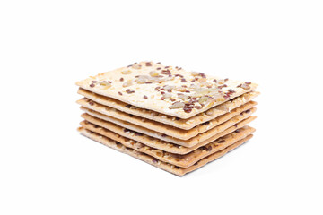Multigrain crispbread with sesame, flax and sunflower seeds isolated on white background. Healthy snack 