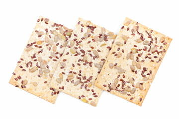 Multigrain crispbread with sesame, flax and sunflower seeds isolated on white background. Healthy snack. Top view 