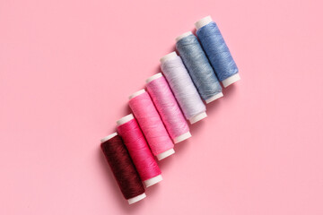 Thread spools on pink background