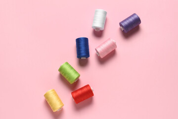 Thread spools on pink background
