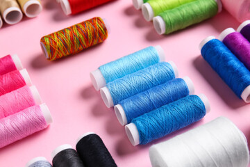 Thread spools on pink background