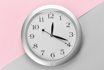 New modern clock on color background