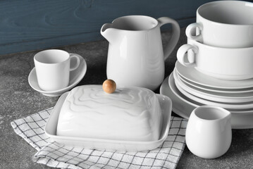 Fototapeta na wymiar Set of stylish dinnerware on grey wooden background