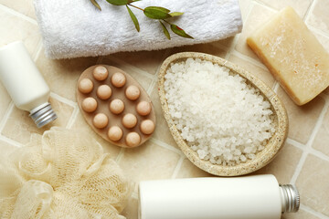 Set of bath supplies with massage soap on color tile