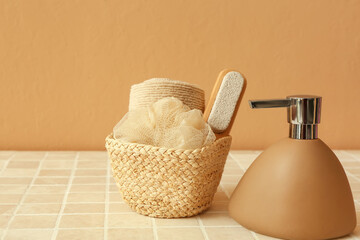 Fototapeta na wymiar Basket with bath accessories and bottle of cosmetic product on table