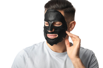 Handsome man with black facial mask on white background
