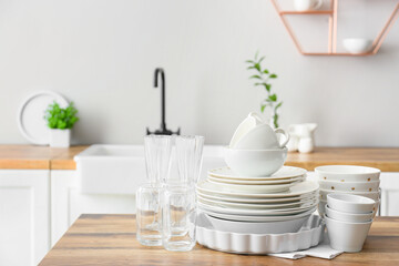Fototapeta na wymiar Beautiful dinnerware on wooden counter in light kitchen