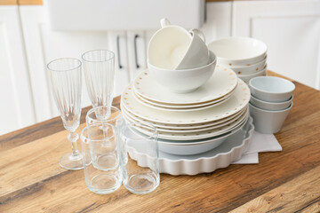 Beautiful dinnerware on wooden counter in light kitchen