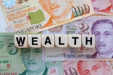 Wealth signage on a background of Singapore dollars.