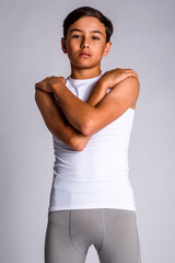 Fototapeta na wymiar Male youth sports athlete standing with arms crossed and hands on shoulders