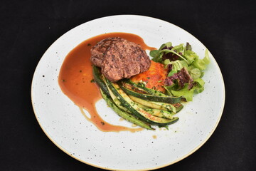 spicy steak with avocado and salad