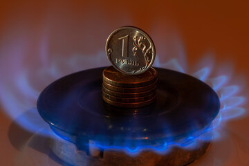 Coin 1 Russian ruble stands on a hot gas burner