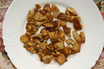 mushrooms fried with goldene apples sliced on a white plate in Bistrita,Romania