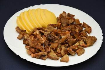 mushrooms fried with goldene apples sliced on a white plate in Bistrita,Romania