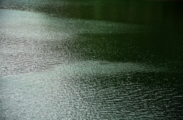 Fototapeta na wymiar Bistrita,ROMANIA, Colibita Lake Lake water,abstract,texture reflexion and waves