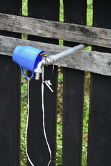 faucet and blue cup at The Orthodox Monastery "The Dormition of the Virgin Mary" Nicula, Romania,