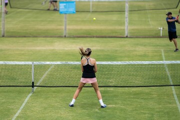 Amateur playing tennis at a tournament and match on grass in Melbourne, Australia 