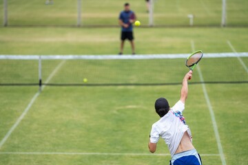 Amateur playing tennis at a tournament and match on grass in Melbourne, Australia 